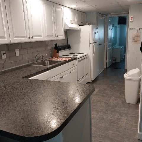 Updated kitchen with white cabinets and appliances